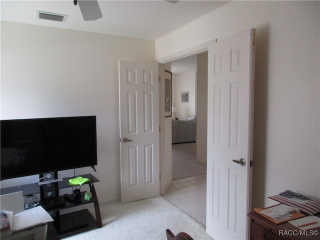 office area featuring light carpet and ceiling fan