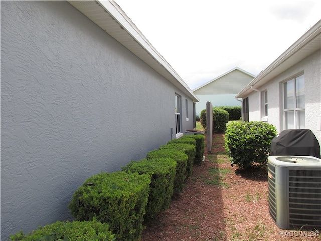 view of side of home featuring cooling unit