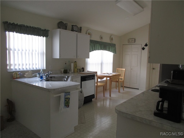 kitchen featuring kitchen peninsula, sink, dishwasher, white cabinets, and lofted ceiling