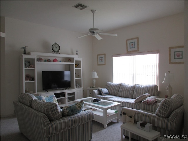 carpeted living room with ceiling fan