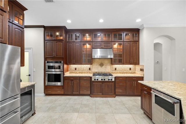 kitchen featuring wine cooler, light stone countertops, dark brown cabinets, and stainless steel appliances