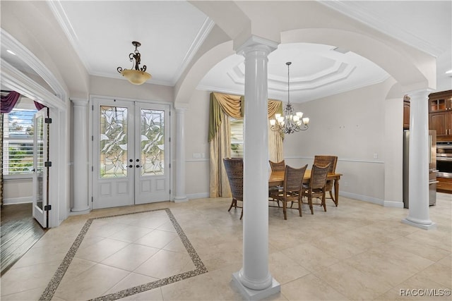 tiled entryway with plenty of natural light, ornamental molding, french doors, and ornate columns