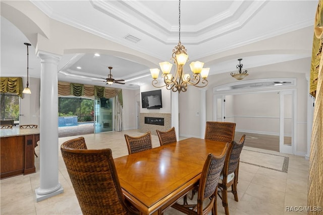 dining area featuring crown molding, ceiling fan, a raised ceiling, and ornate columns