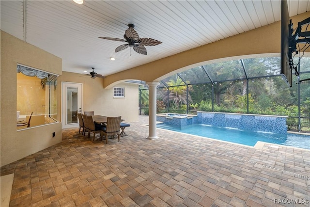 view of swimming pool with a patio, pool water feature, ceiling fan, and an in ground hot tub