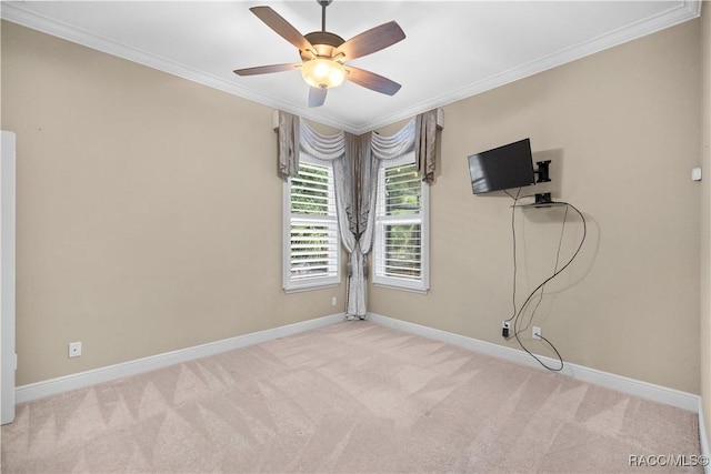 spare room with crown molding, light carpet, and ceiling fan