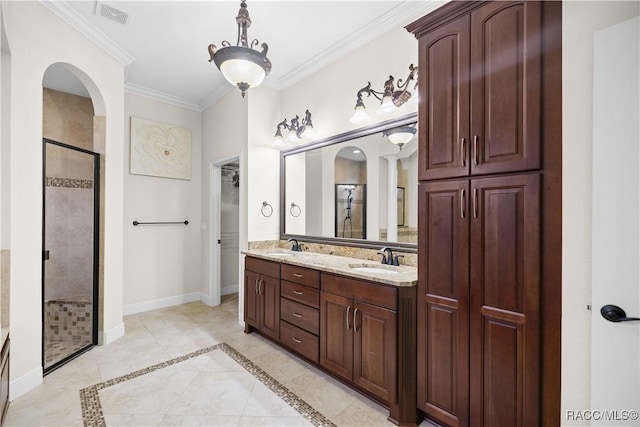 bathroom with crown molding, vanity, and an enclosed shower