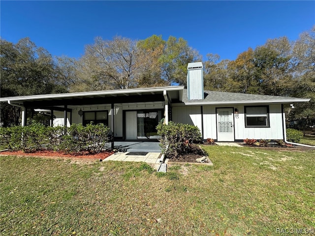 rear view of house featuring a yard