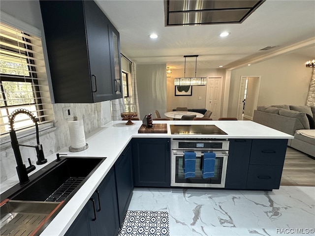 kitchen featuring stainless steel oven, sink, tasteful backsplash, pendant lighting, and black electric cooktop