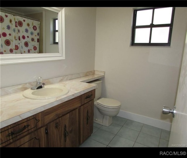 bathroom with vanity, tile patterned floors, and toilet