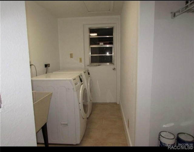 laundry area with washer and dryer and light tile patterned flooring