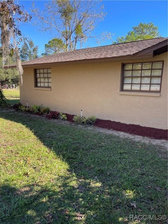 view of property exterior featuring a yard