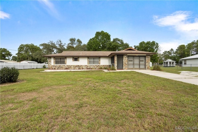 5761 S Eaton Ter, Inverness, FL 34452 - view of front of property with stone siding, driveway, and an attached garage