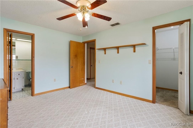 5761 S Eaton Ter, Inverness, FL 34452 - unfurnished bedroom with a walk in closet, a closet, baseboards, and ensuite bathroom