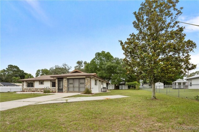 5761 S Eaton Ter, Inverness, FL 34452 - view of front of property with stone siding, driveway, and an attached garage