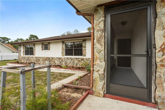 5761 S Eaton Ter, Inverness, FL 34452 - doorway to property with stone siding and stucco siding