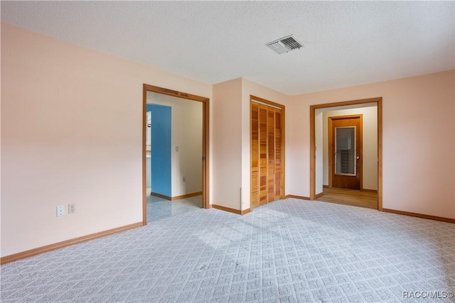 5761 S Eaton Ter, Inverness, FL 34452 - empty room with light colored carpet, baseboards, and a textured ceiling
