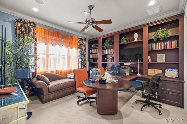 carpeted office with crown molding and ceiling fan