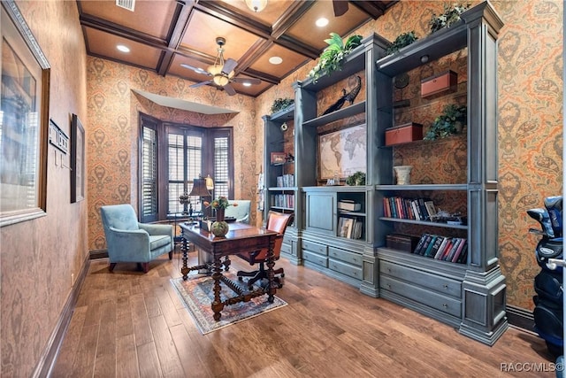 office area featuring beamed ceiling, wood-type flooring, coffered ceiling, and ceiling fan