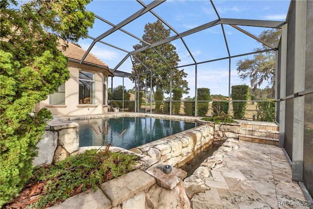 view of pool featuring a lanai and a patio