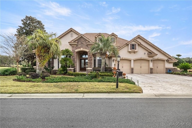 view of front of house with a garage and a front yard