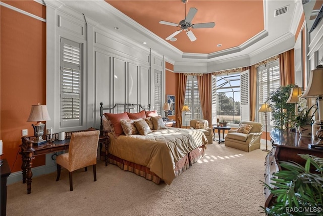 bedroom with crown molding, carpet flooring, and a tray ceiling