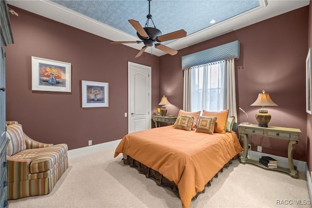 carpeted bedroom featuring a textured ceiling and ceiling fan