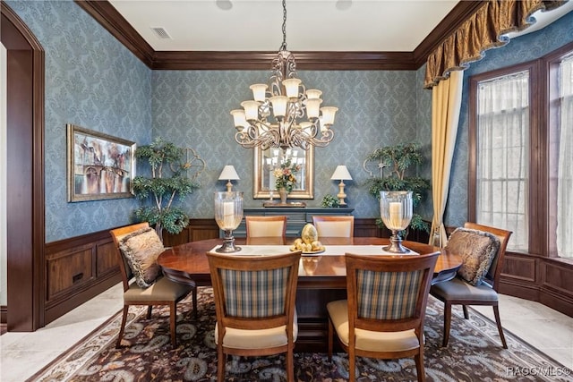 dining room featuring an inviting chandelier and crown molding