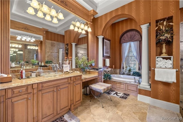 bathroom featuring crown molding, decorative columns, and a tub