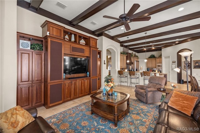 tiled living room featuring beam ceiling and ceiling fan