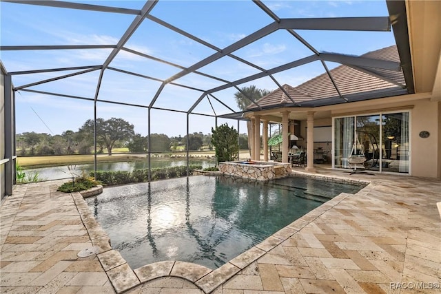 view of pool featuring a water view, a patio, a lanai, and an in ground hot tub