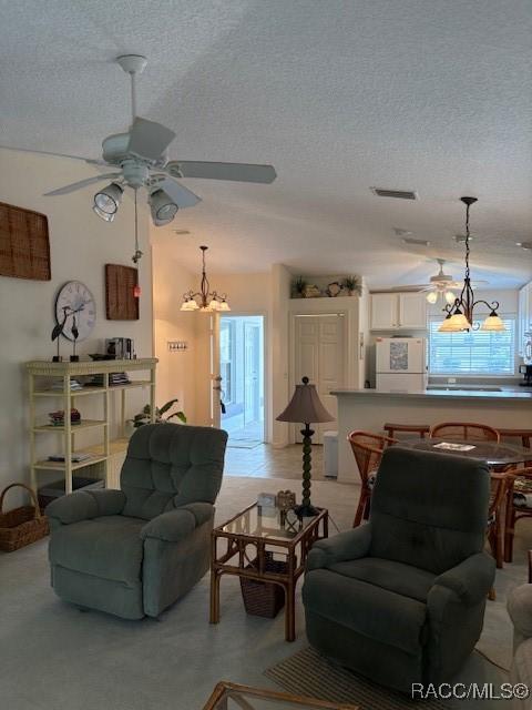 11246 W Freshwater Path, Crystal River, FL 34428 - living area with a chandelier, a textured ceiling, and ceiling fan