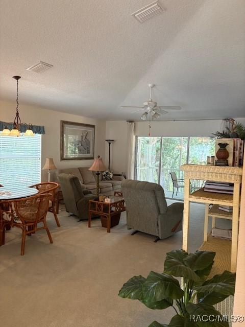 11246 W Freshwater Path, Crystal River, FL 34428 - living room with healthy amount of natural light, ceiling fan, light carpet, a textured ceiling, and lofted ceiling