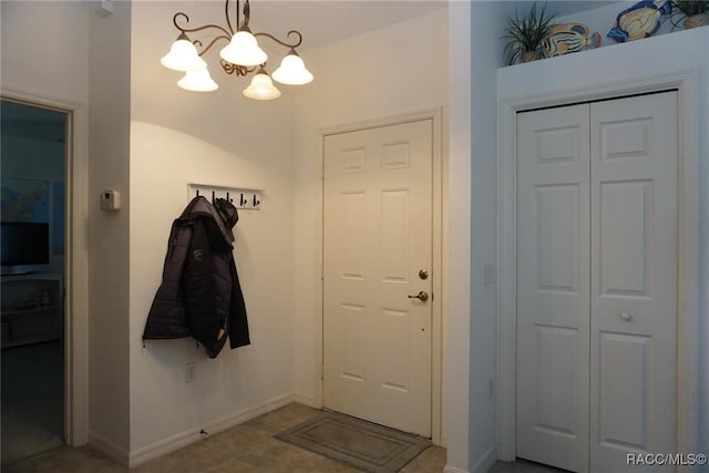 doorway with a notable chandelier