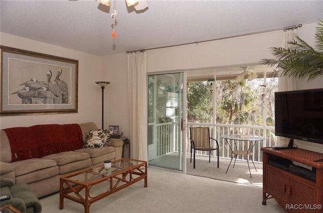 carpeted living room with ceiling fan