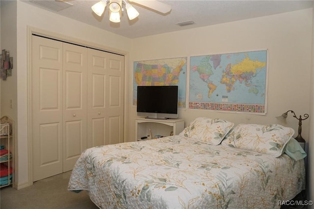 carpeted bedroom featuring a closet and ceiling fan