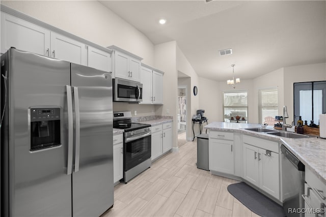 kitchen with white cabinets, a notable chandelier, sink, and stainless steel appliances