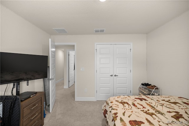 carpeted bedroom featuring a closet