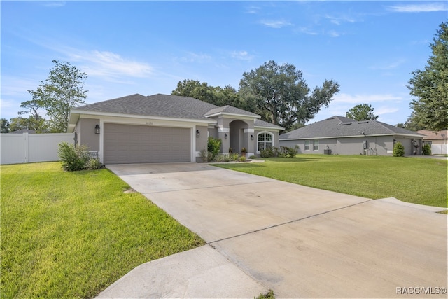 single story home featuring a front lawn and a garage