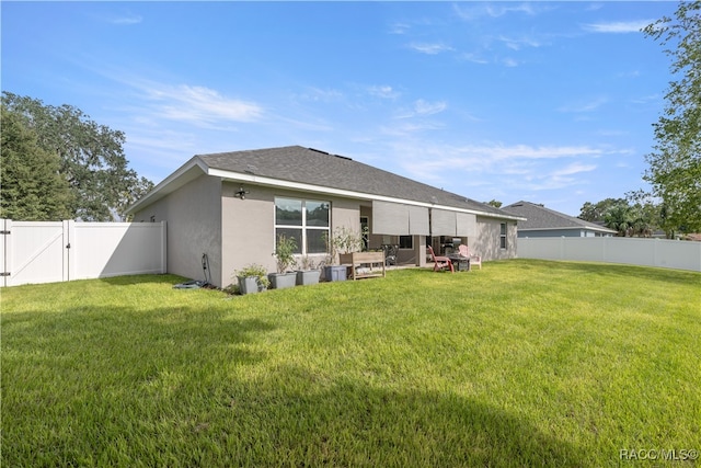 rear view of house with a lawn