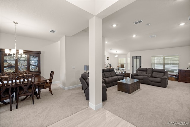 living room featuring a chandelier and light colored carpet