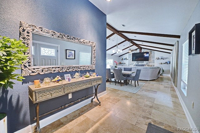 interior space with plenty of natural light and lofted ceiling with beams