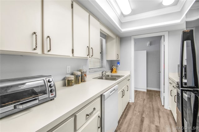 kitchen featuring light wood-type flooring, white cabinets, crown molding, sink, and dishwasher