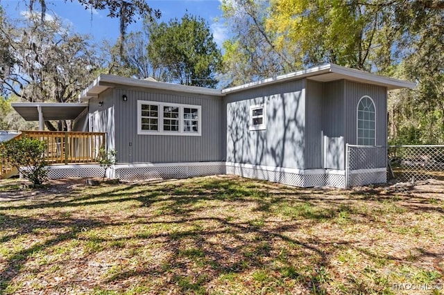 383 S Rooks Ave, Inverness, FL 34453 - rear view of property featuring fence and a wooden deck