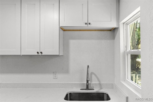 383 S Rooks Ave, Inverness, FL 34453 - kitchen with white cabinets, a textured wall, light countertops, and a sink