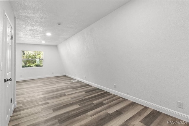 383 S Rooks Ave, Inverness, FL 34453 - empty room featuring baseboards, a textured ceiling, and wood finished floors