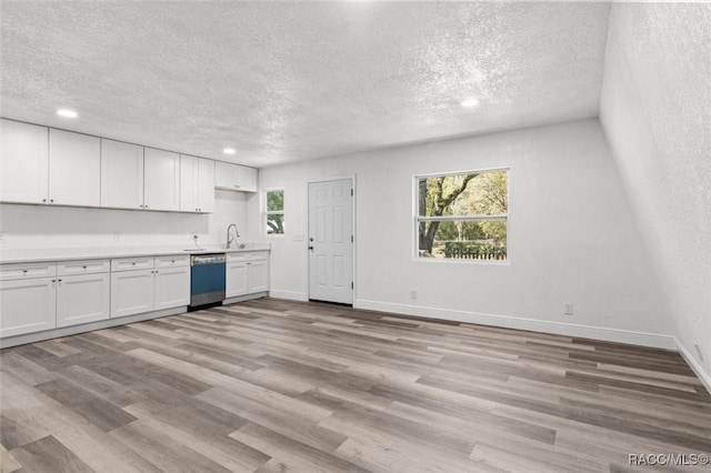 383 S Rooks Ave, Inverness, FL 34453 - kitchen with baseboards, white cabinets, light wood-style flooring, and dishwashing machine