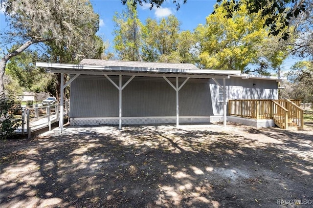 383 S Rooks Ave, Inverness, FL 34453 - back of house featuring a carport