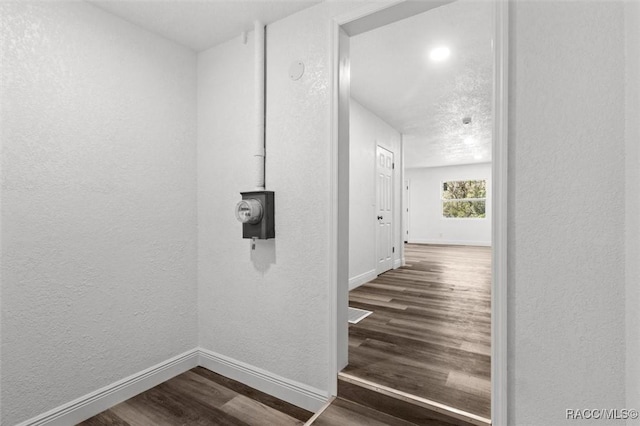 383 S Rooks Ave, Inverness, FL 34453 - hallway with a textured wall, baseboards, and dark wood finished floors