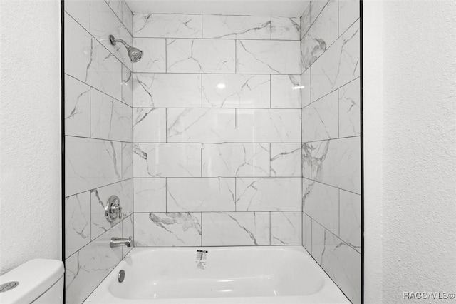 383 S Rooks Ave, Inverness, FL 34453 - full bath with toilet, a textured wall, and washtub / shower combination