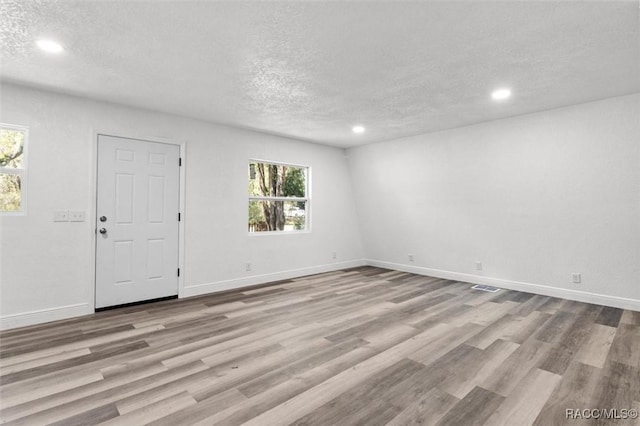 383 S Rooks Ave, Inverness, FL 34453 - unfurnished room featuring baseboards, a textured ceiling, and wood finished floors